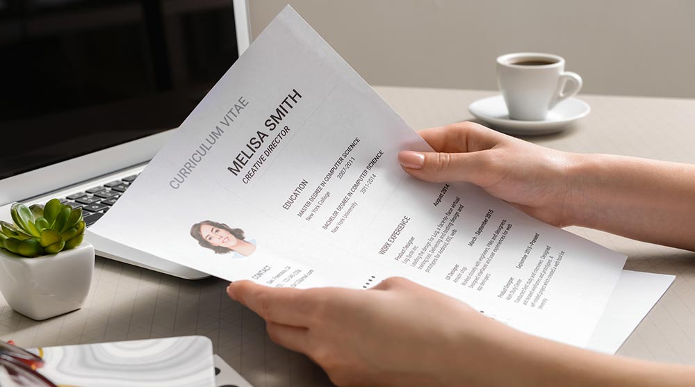 What is a Recruiter and How Do I Find One? Recruiter looking at resume