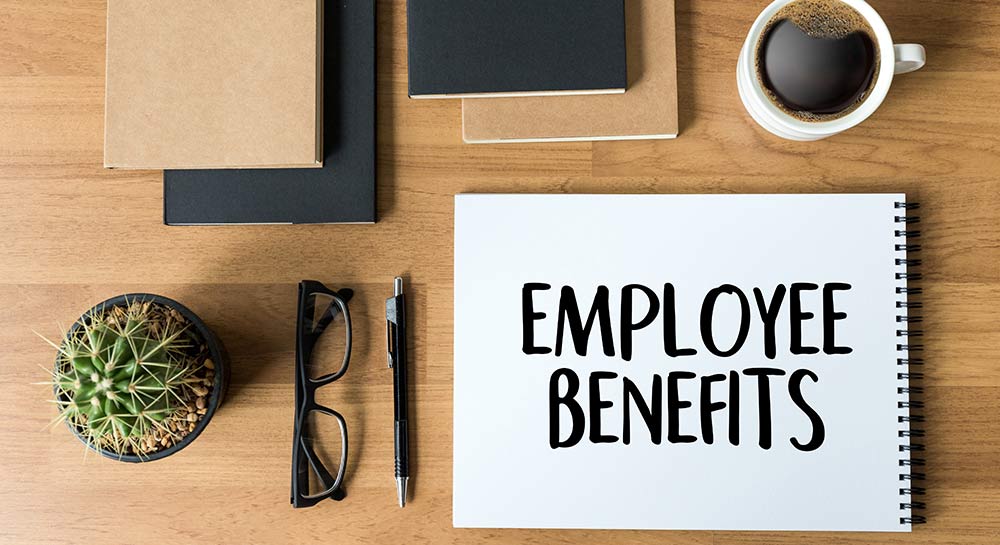 Paid Leave and Flexible Benefits aren’t Just Perks (employee benefits notebook on desk)